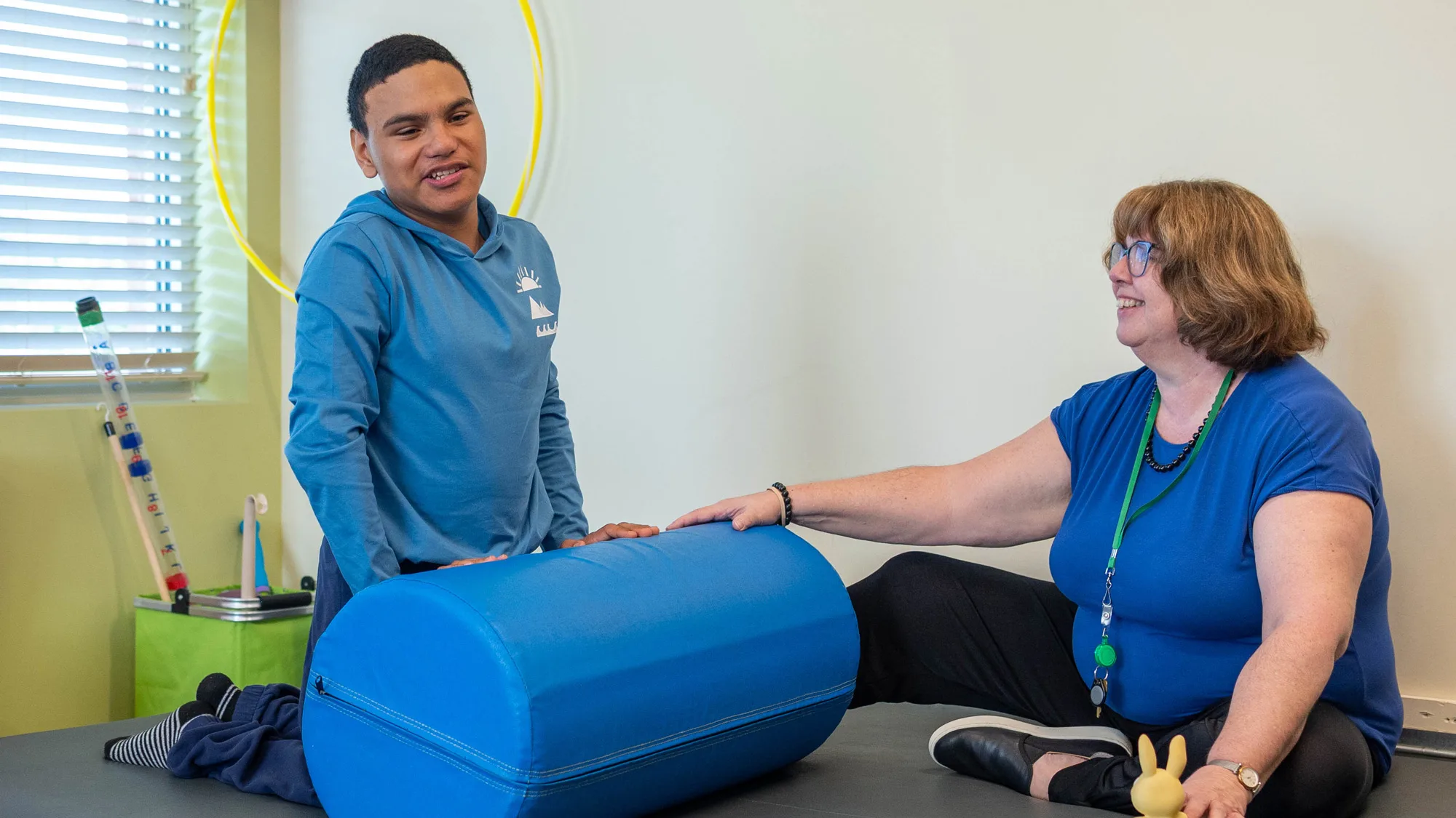 boy and therapist on mat