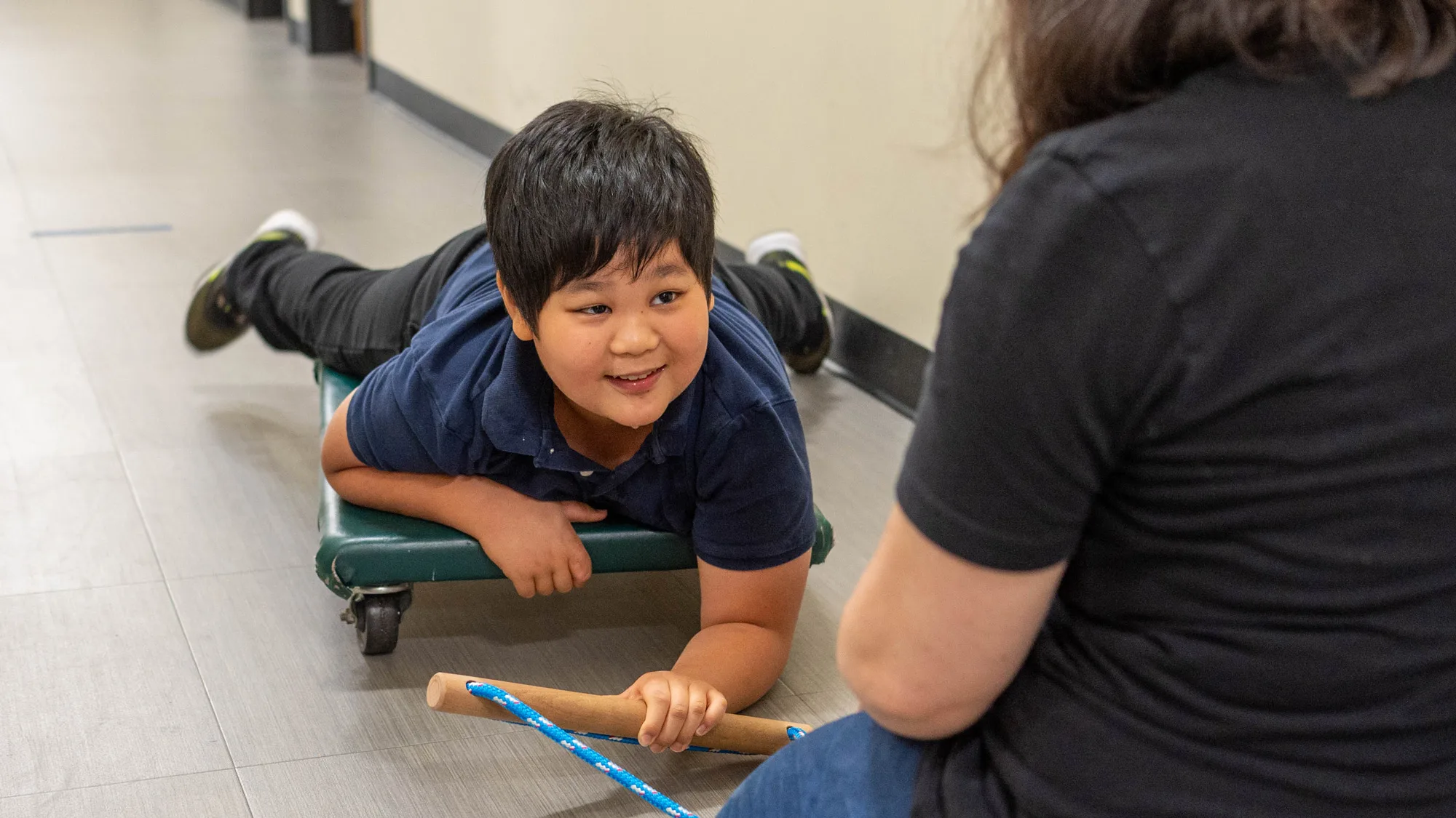 boy laying on rolling platform